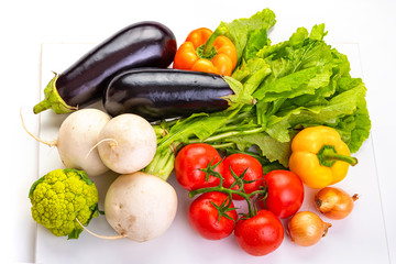 Vegetables for cooking. Eggplant, tomatoes, onions, paprika, cauliflower, white radish.