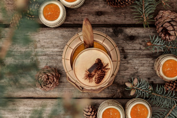 A barrel of honey. Pine and spruce branches. Cones. A barrel of honey. Fresh honey. Honey barrel in his hands. A barrel of honey with a spoon. Tree. Wooden background