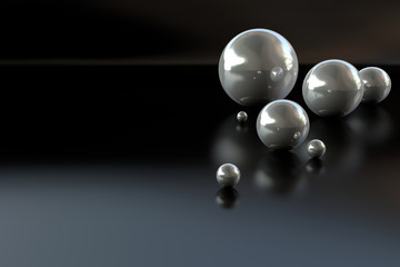 Metal balls on a dark background. Futuristic abstraction. Reflection. A 3D illustration.