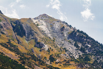 Fototapeta na wymiar Mountainous landscape with rocky peaks and clouds