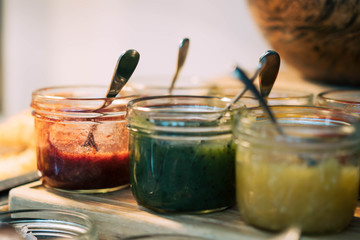 Homemade jars of variety fruits jam on the table
