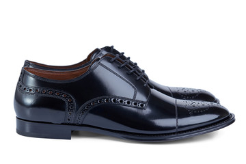 Men's classic shoes derby made of glossy black patent leather on laces with perforated pattern. Side view.