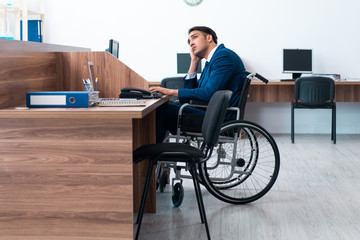 Young male employee in wheel-chair