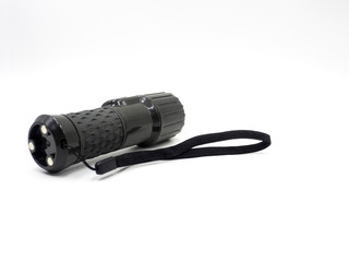 A black flashlight isolated on white background