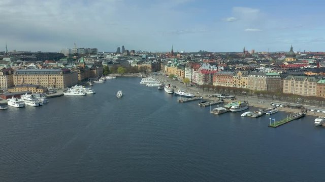 Aerial view of Nybroviken, Stockholm City. Flying over water toward the skyline.