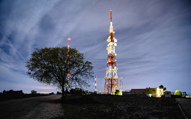 view of the antennas at night high up on the mountain
