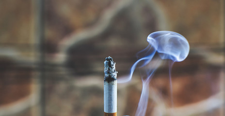 cigarette with blue smoke on a black background