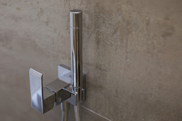 Shower on the wall in the bathroom.