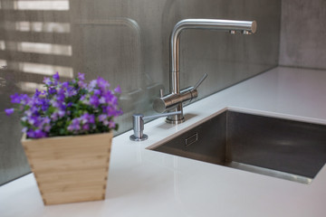 Kitchen interior with furniture and a large table and sink.