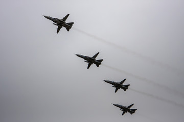 Fototapeta na wymiar Combat aircraft fly in formation on May 9 Victory Parade