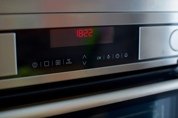 Oven control panel in the kitchen.
