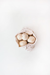 mushrooms in zero waste bag on the white background