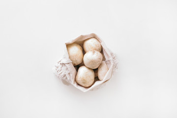mushrooms in zero waste bag on the white background