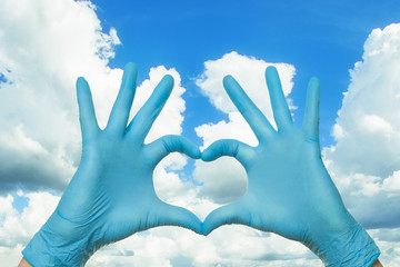 Medicine and treatment concept. Doctor hands making heart on sky