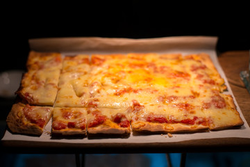 Homemade rectangular pepperoni pizza in warm light