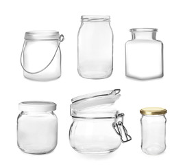 Set with different empty glass jars on white background