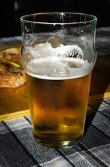 closeup of half-filled glass of beer