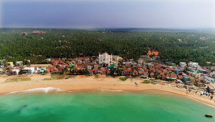 Fototapeta na wymiar Top view of beautiful white sand beach with turquoise sea water and palm trees, aerial drone shot