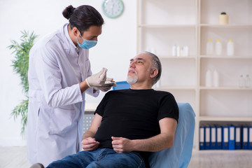 Old man visiting young doctor for plastic surgery