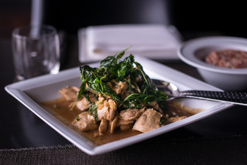 fried sliced chicken topped with deep fried sweet basil leaves