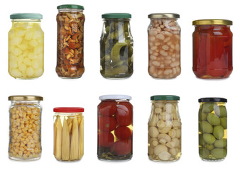 Set of different jars with pickled vegetables and mushrooms on white background