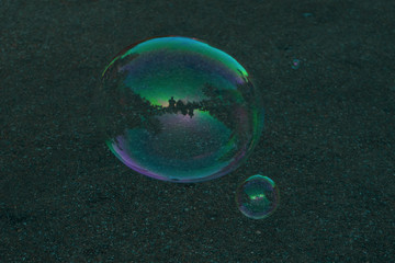 A soap bubble with reflection inside a small kiosk.