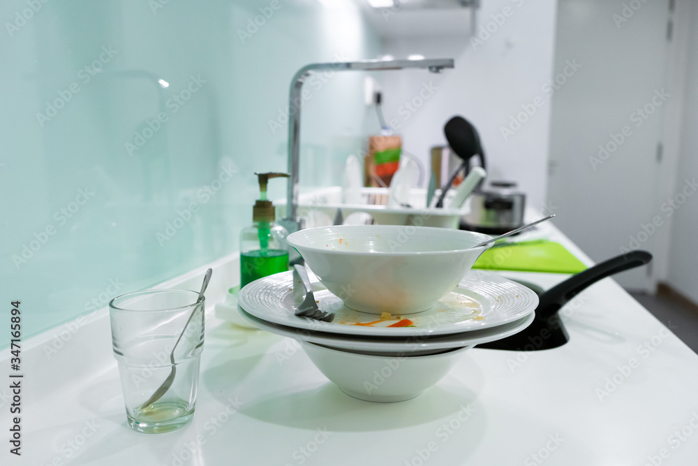 Wall mural A mountain of dirty dishes in the kitchen sink. Mess in the house