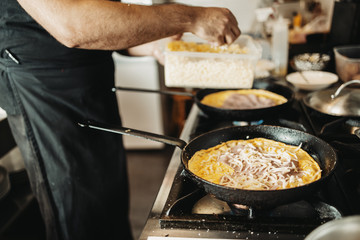 Professional chef working in restaurant kitchen and making delicious traditional food.