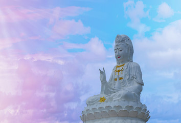 White statue goddess of mercy,  Statue of GuanYin  on pastel sky background