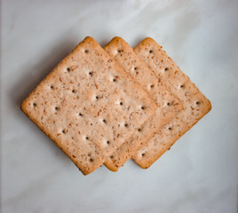 Flat lay. Top view. Lean ruddy crackers with bran lie on a white background