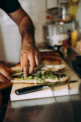 Professional chef working in restaurant kitchen and making delicious traditional food.