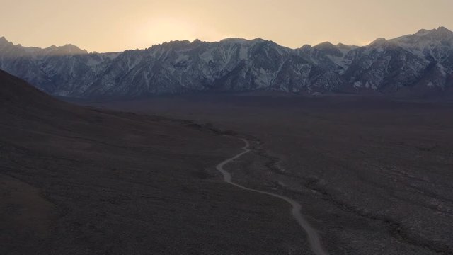 An aerial tracking shot of Mt. Whitney and the Sierra Nevada Mountains from Moffat Ranch Road in Lone Pine, CA.