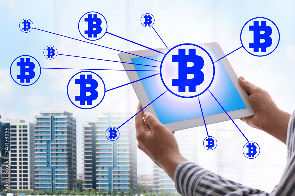 Poster fintech concept. scheme with bitcoin symbols and man using tablet on cityscape background