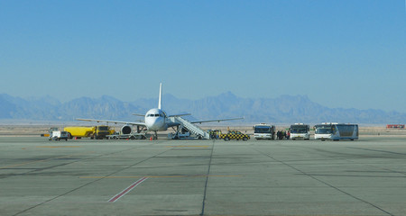 Fototapeta premium Airplane aircraft service at the mountain international airport
