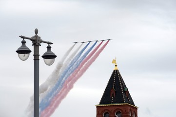 A group of Su-25 "Grach" attack aircraft smoke with the colors of the Russian flag in the sky over Red Square during a parade dedicated to the 75th anniversary of Victory 