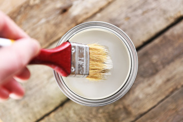 Brush dipped in a jar with paint close-up.Dip brush into the paint.