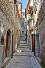 Fototapeta na wymiar A narrow street between old buildings in the medieval town of Cusano Mutri, in the province of Avellino