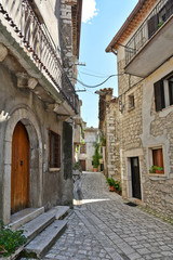 A narrow street between old buildings in the medieval town of Cusano Mutri, in the province of Avellino
