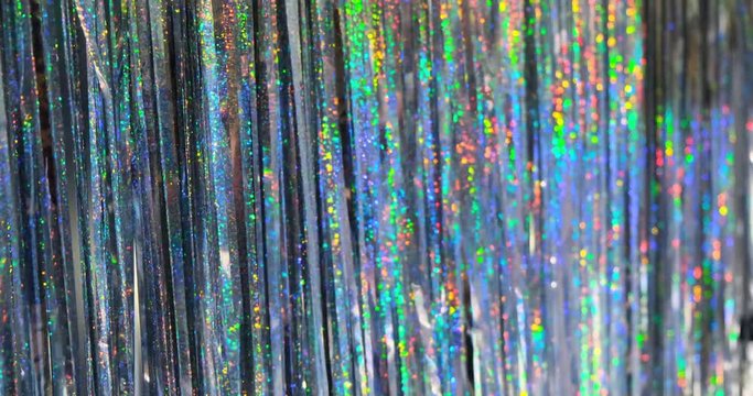 Women having fun at the party, near blue iridescent fringe foil curtain party decoration. Backdrop party curtain, photoshoot decoration, glitters, birthday party, hen-party, bride-to-be