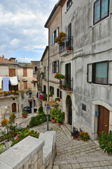 A narrow street between old buildings in the medieval town of Cusano Mutri, in the province of Avellino