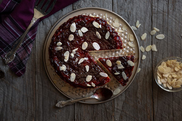 Homemade delicious cheesecake with fruit jam and almonds