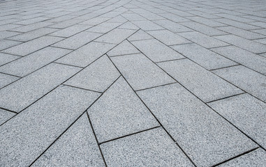 A pavement made of rectangular stone slabs.