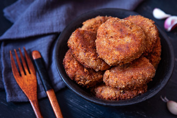 Juicy homemade cutlets beef, pork, chicken on a black background. The top view
