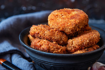 Juicy homemade cutlets beef, pork, chicken on a black background. The top view