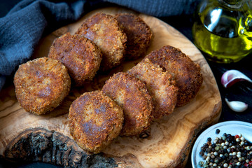 Juicy homemade cutlets beef, pork, chicken on a wood board background. The top view