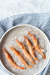 Fresh raw prawns prepared for cooking with pepper, lemon and parsley