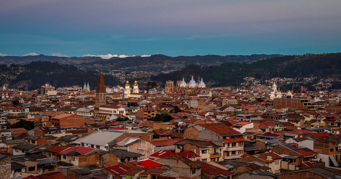 View of the city of Cuenca in the golden hour, just after sunset and close to night time, with it's cathedral and many churches. Cuenca, Azuay Province, Ecuador, South America.