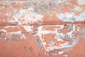 Pink concrete wall with chipped and scratches. Aged texture and background