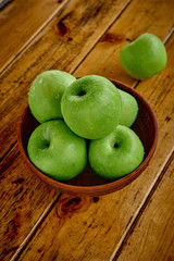 green apples on the table after rain