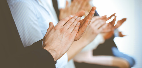 Business people clapping and applause at meeting or conference, close-up of hands. Group of unknown...